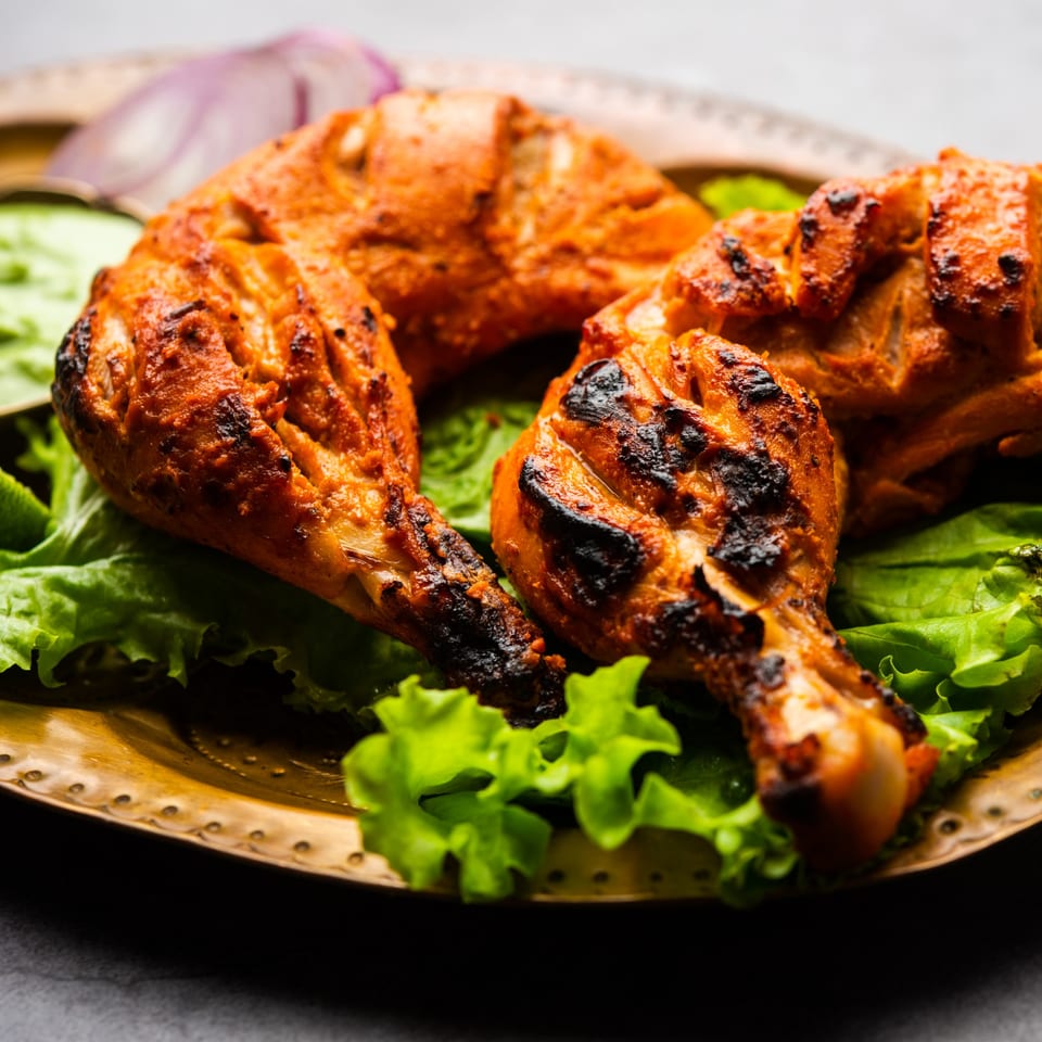 Indian Kitchen Bar & Grill's Tandoori Chicken, served on a bed of fresh lettuce with green chutney.